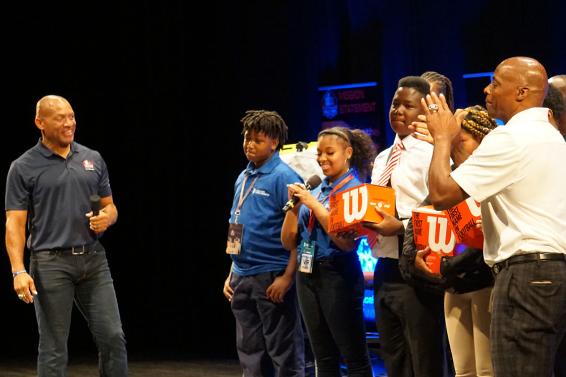 Aeneas Williams and Darrell Williams interact with teenagers on stage