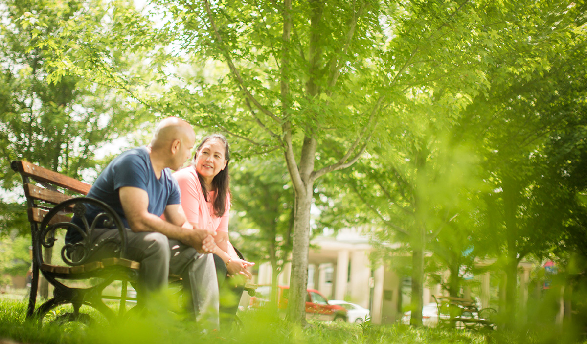 couple sitting on a bench in park