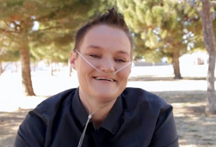 smiling woman with nasal oxygen tube