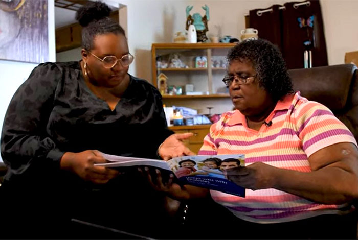 Two women reviewing a diabetes brochure.