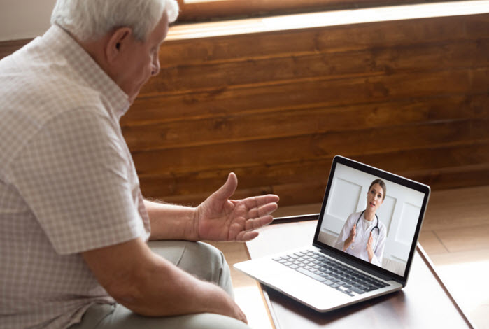 mature man consulting a doctor on his laptop
