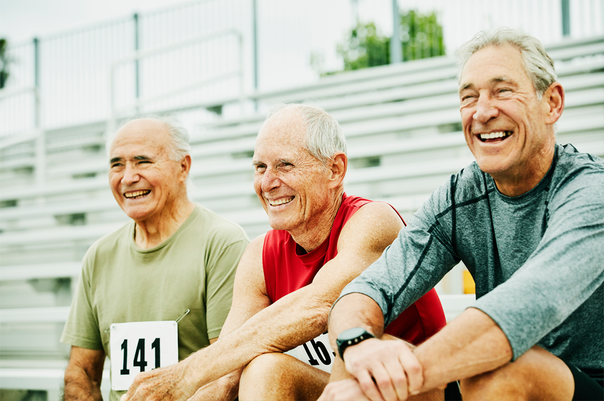 three mature men sitting at a run race