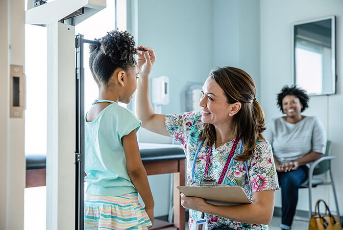 nurse checks child's height